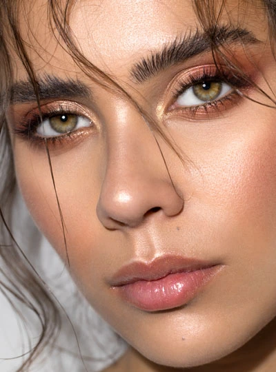 skin_balance_cosmetics_make_up Nahaufnahme eines weiblichen Gesichts mit professionellem Make-up, betonten Augen, schimmernden Lidschatten und glänzenden Lippen.